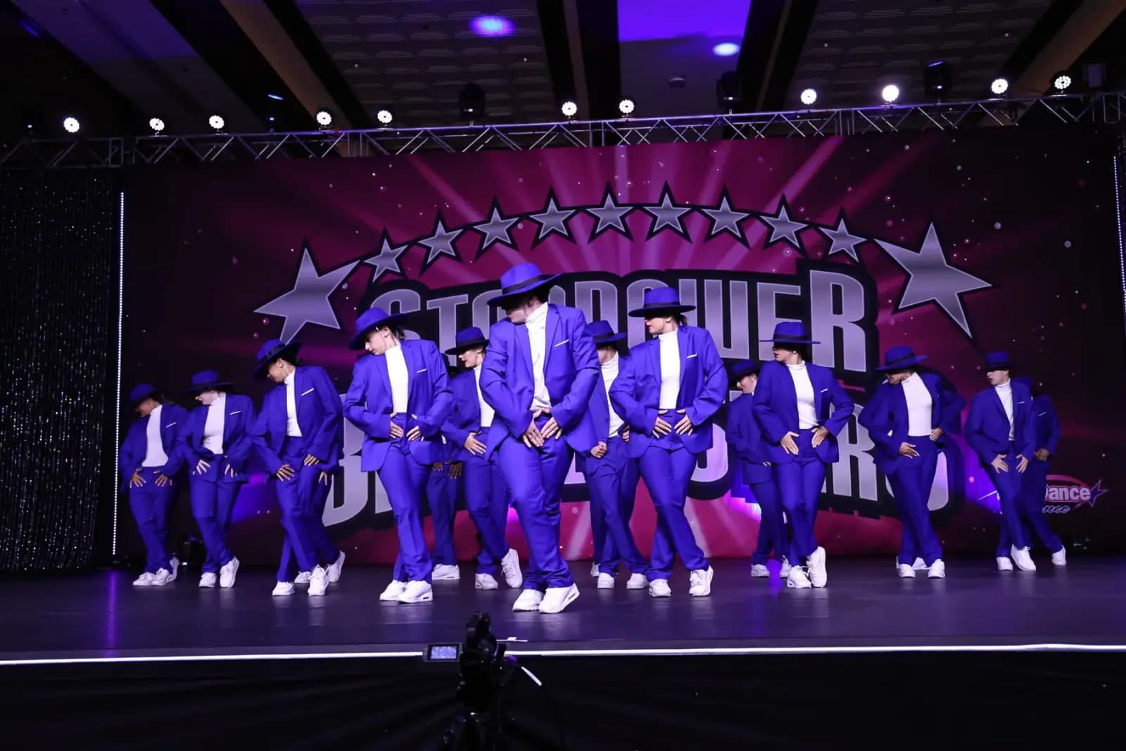 Icon team dancers posing together in the studio.