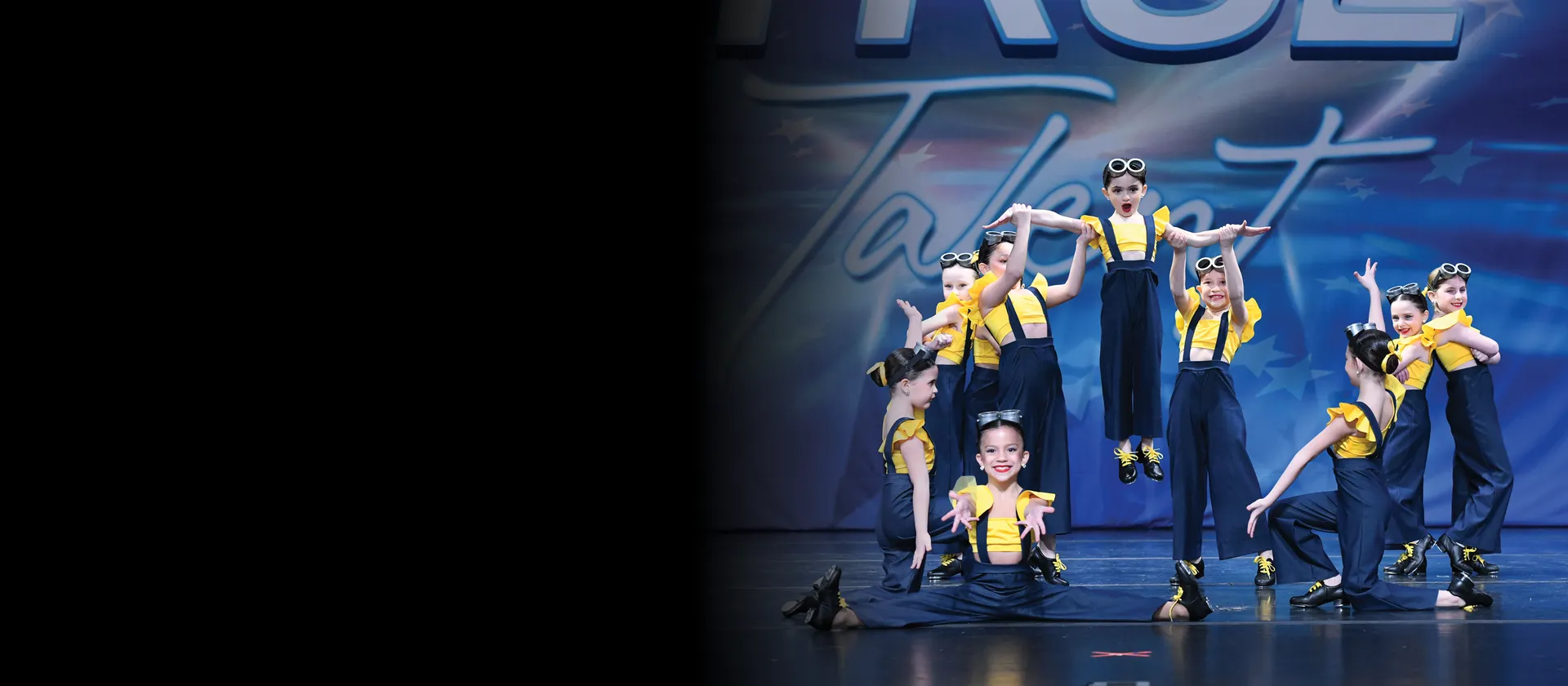 Future ICONs dancers on stage with blue Icon lighting.