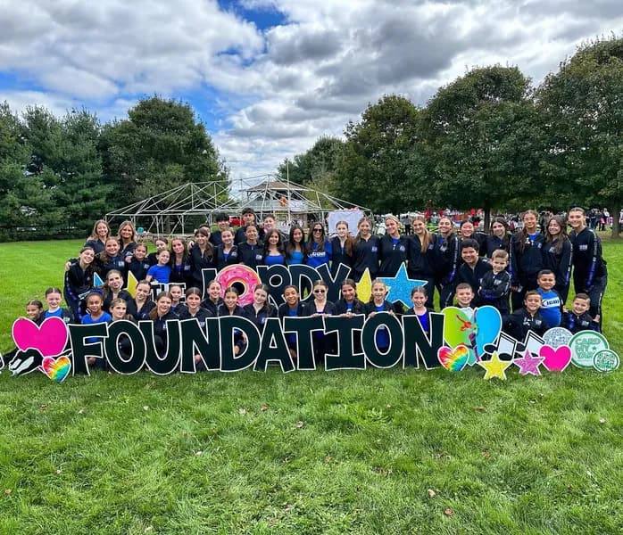 Icon dancers gathered outdoors at a Hope Foundation event.