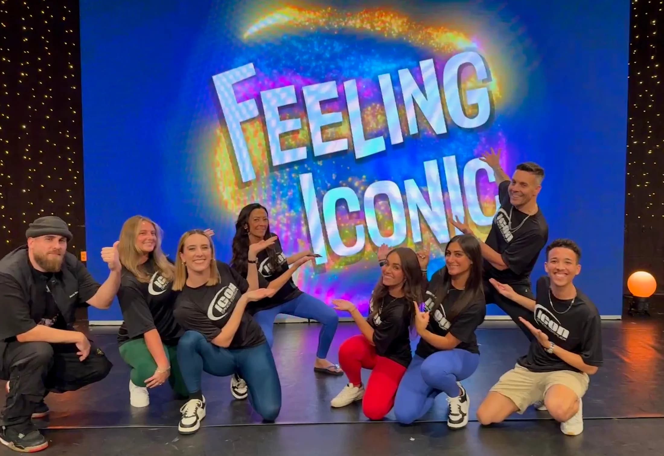 Icon staff on stage in front of the Feeling Iconic screen.