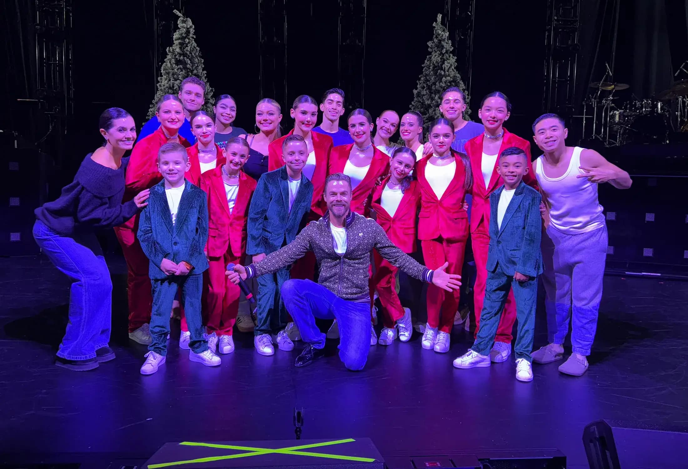 Icon dancers gathered on stage after a performance.