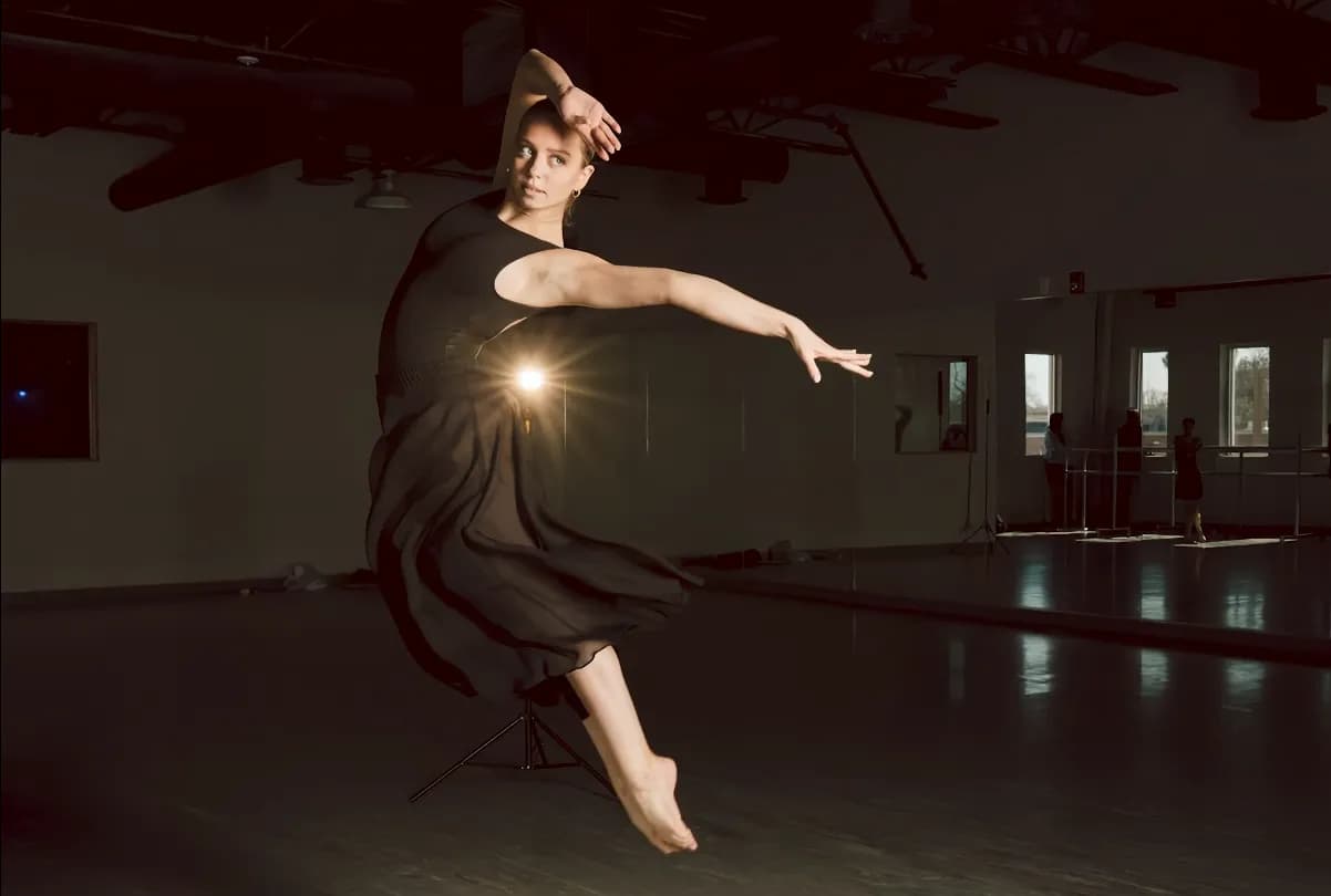 Lyrical dancer extending through a studio combination.