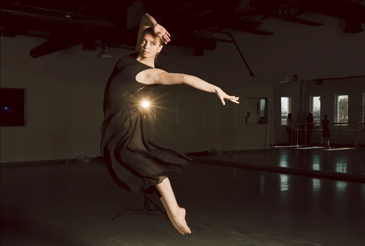 Lyrical dancer extending through a studio combination.