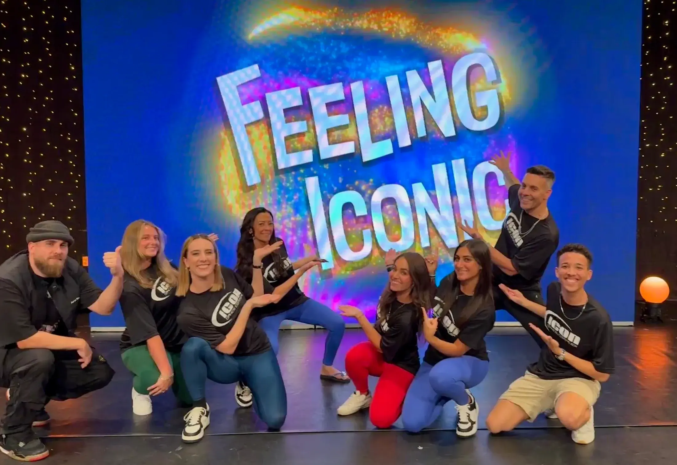 Icon staff on stage in front of the Feeling Iconic screen.