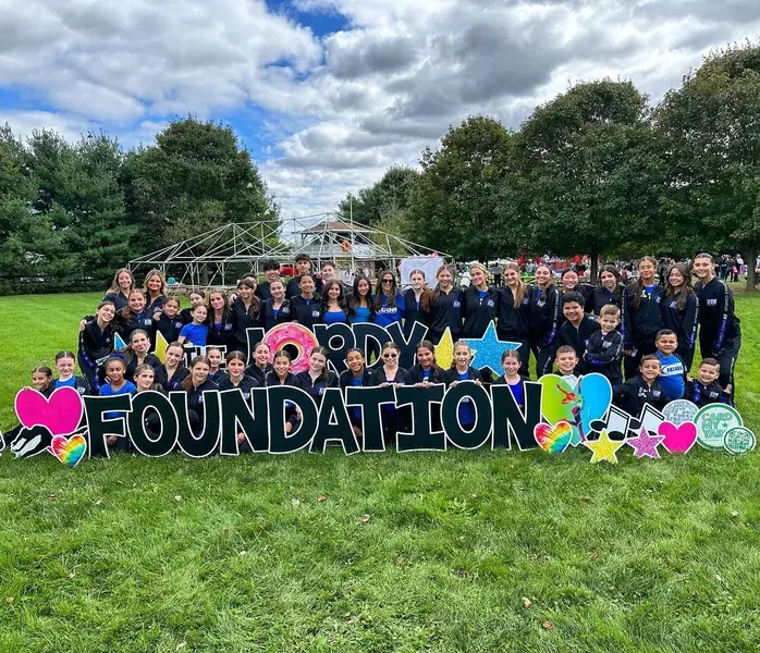 Icon dancers gathered outdoors at a Hope Foundation event.