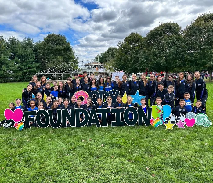 Icon dancers gathered outdoors at a Hope Foundation event.